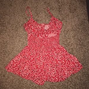 Red romper with a tying bow.